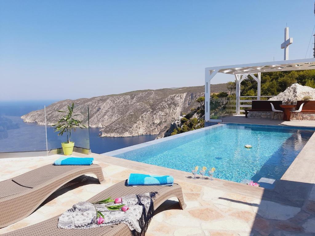 a swimming pool with a view of the ocean at Villa Esperia in Kampion