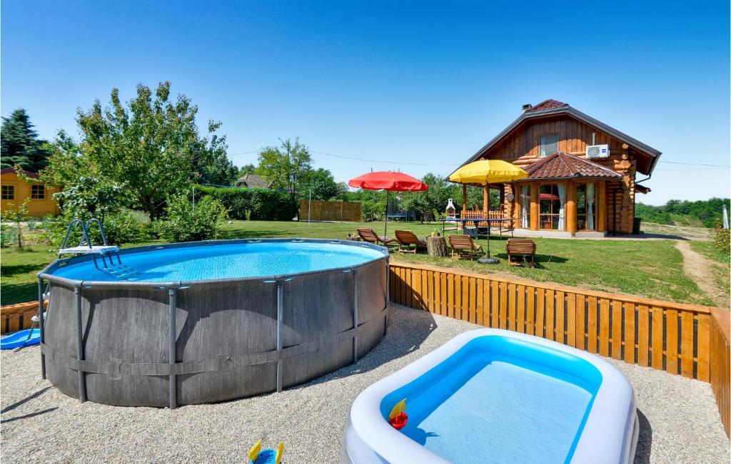 a large swimming pool with a tub next to a house at Gorgeous Home In Vinogradi Ludbreski With House A Panoramic View in Ludbreg