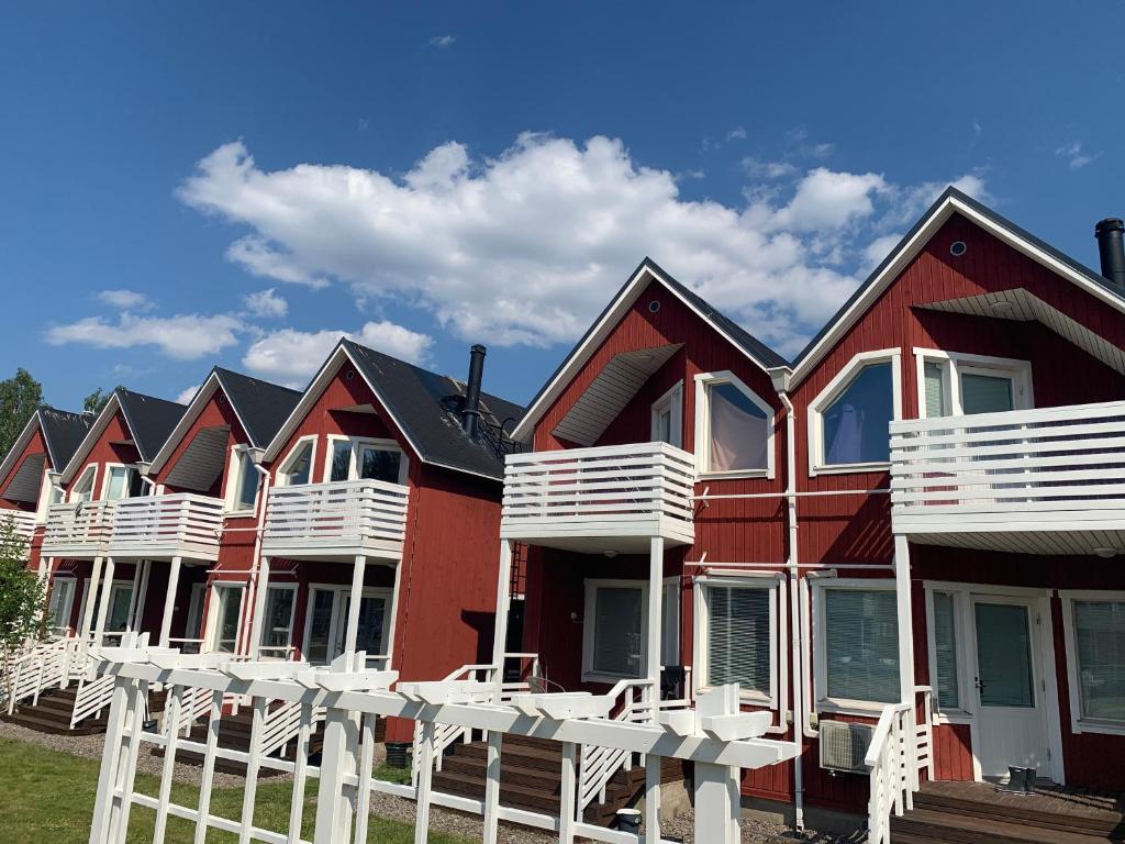 a row of houses with white chairs in front of them at Saimaa Marina Garden Apartments in Lappeenranta