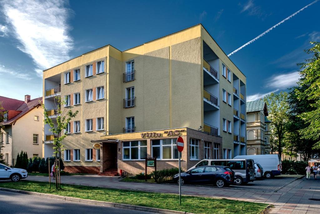 a building with cars parked in front of it at Villa AS in Świnoujście