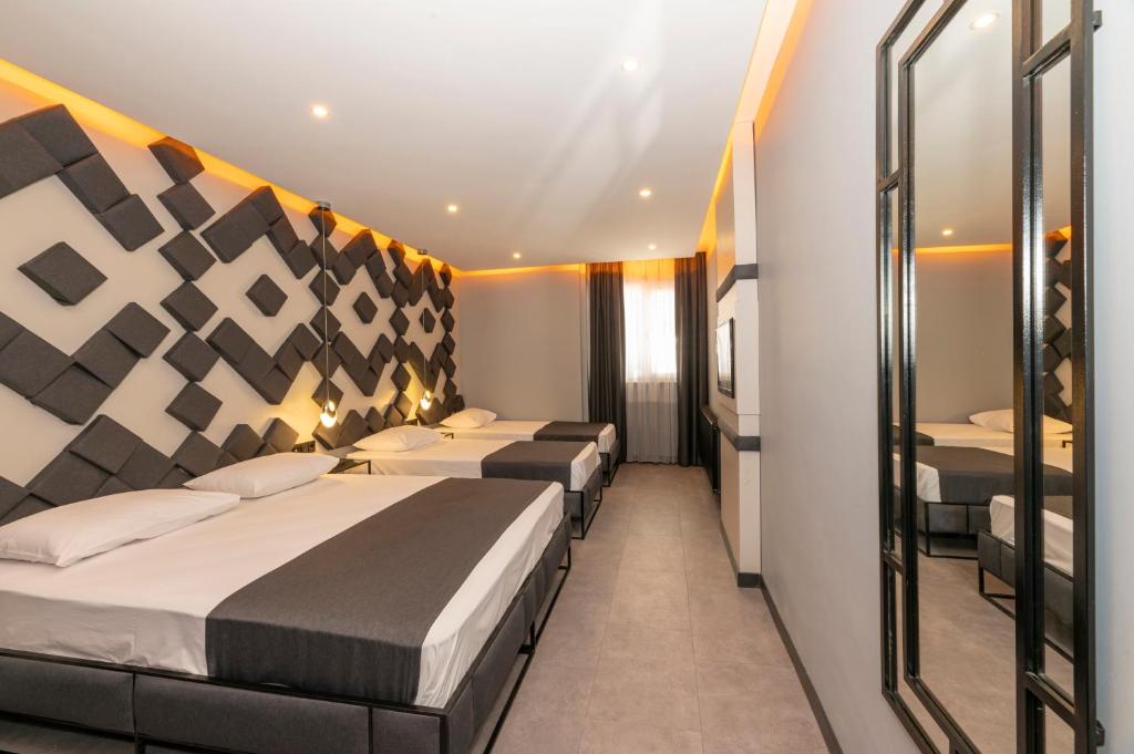 Postel nebo postele na pokoji v ubytování White Palace Hotel