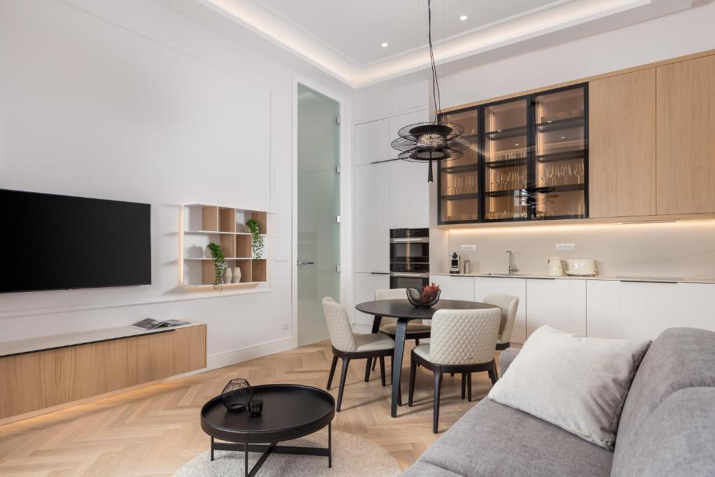 a living room with a couch and a table at Plaza Apartments in Opatija