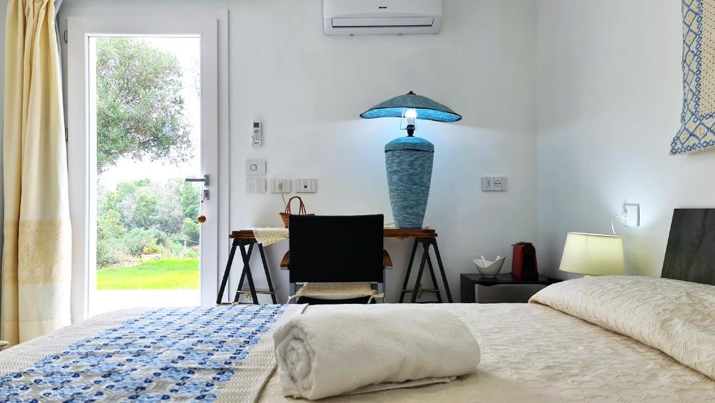 a bedroom with a bed and a blue vase on the wall at Sole Matto Rooms in Olbia