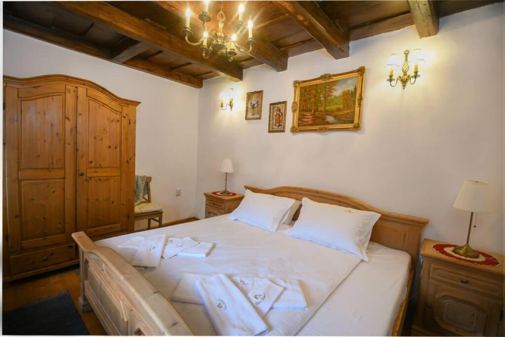 a bedroom with a large bed with white sheets at Casa Lörinczi in Sighişoara