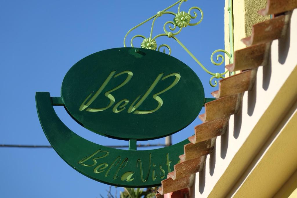 a green sign on the side of a building at BellaVista in Baressa