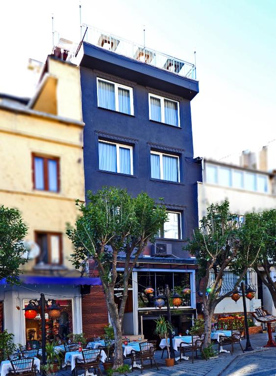 a building with tables and chairs in front of it at The Sunrise Hotel in Istanbul