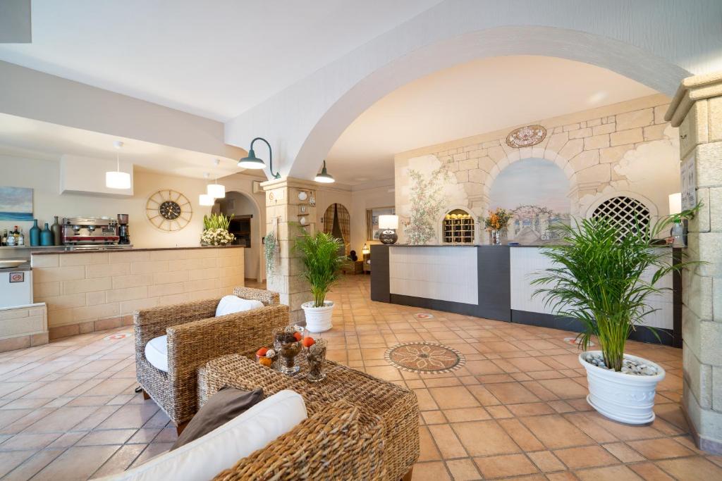 sala de estar con 2 sofás y cocina en Hotel Costa D'Oro en Torre Ovo