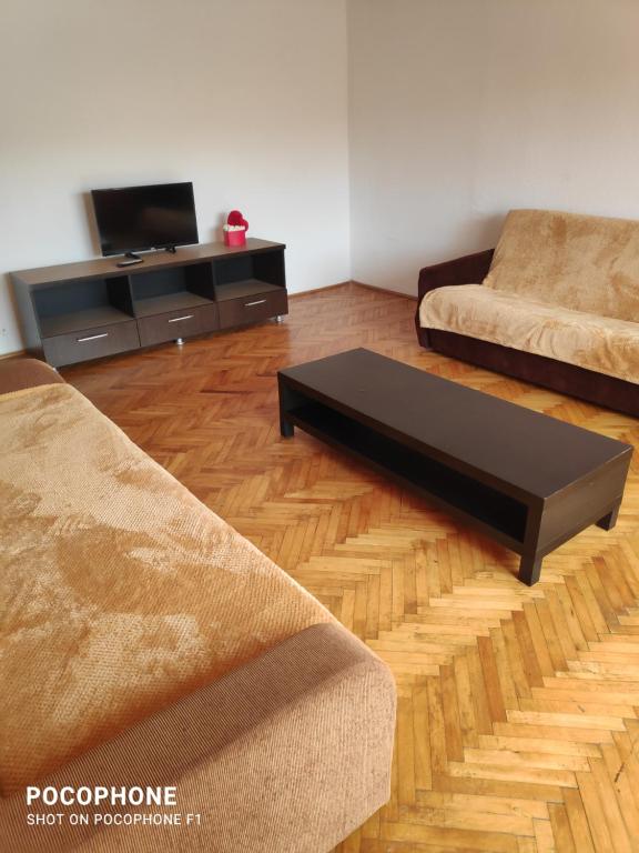 a living room with two couches and a coffee table at Iris&carina in Eforie Sud