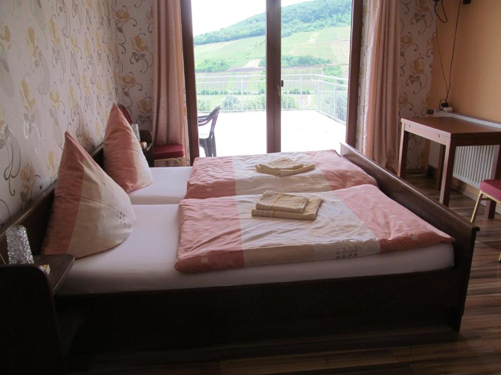a bed in a room with a large window at Pension Simon in Reil