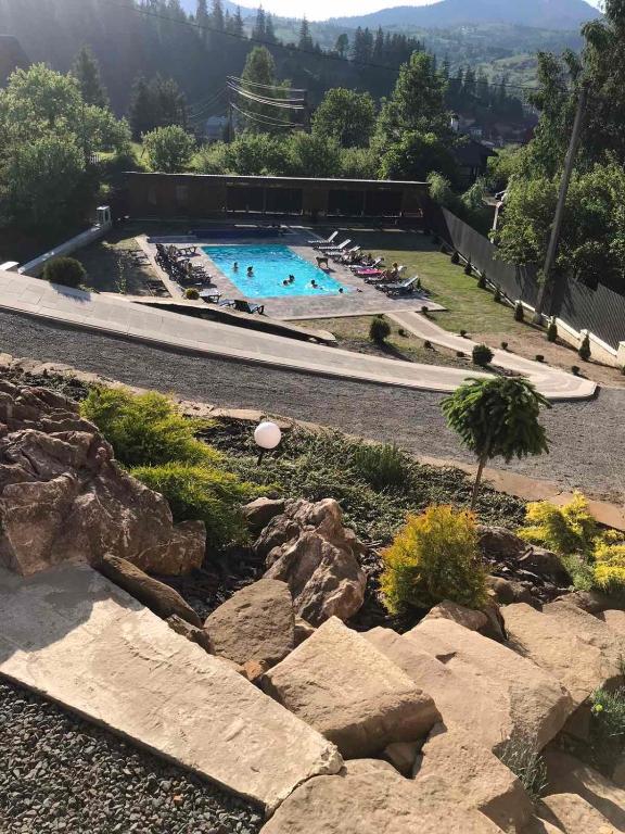 a large swimming pool with rocks in a yard at Provence in Slavske