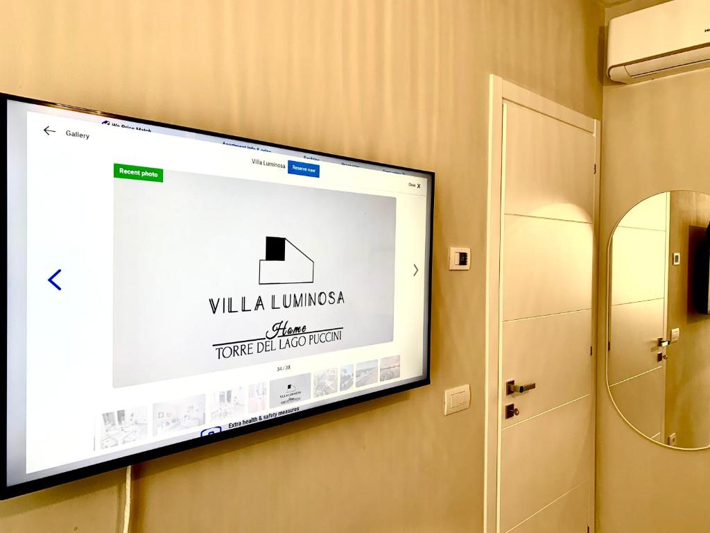 a flat screen tv hanging on a wall at Villa Luminosa in Torre del Lago Puccini