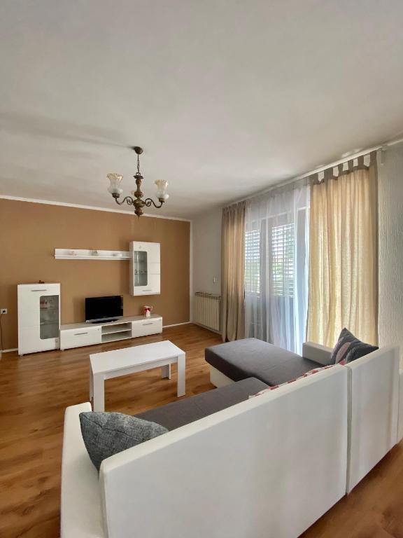 a living room with a couch and a table at Apartman Mira in Opatija