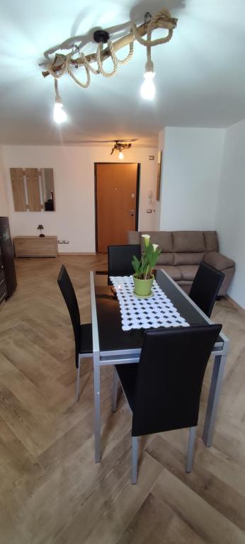 a dining table and chairs in a living room at Manuel Guesthouse Arta terme in Arta Terme