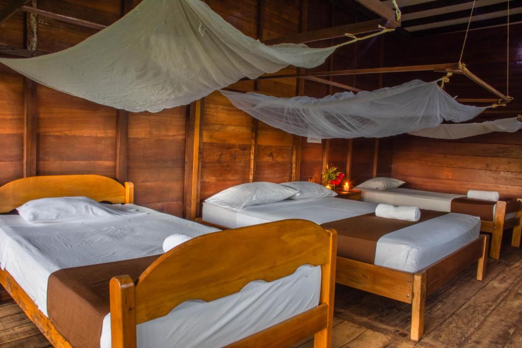 Postel nebo postele na pokoji v ubytování Wasai Tambopata Lodge