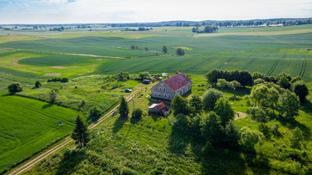 an aerial view of a house in a green field at Miejsce Mocy Mazury in Kolno