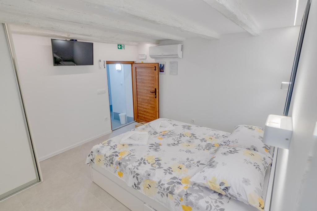 a small bedroom with a bed and a mirror at Apartment light in Pula in Pula