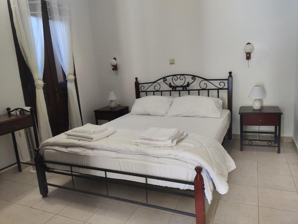 a bedroom with a bed with towels on it at Gompos Apartment - Cozy Apartment next to the sea - Amazing Sea View in Symi