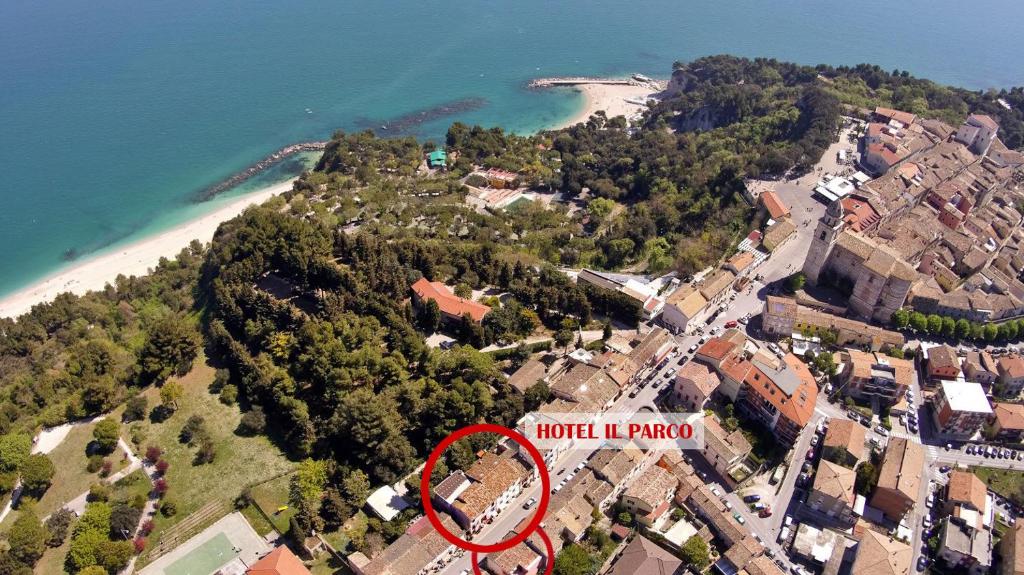 uma vista aérea de uma casa numa colina ao lado de uma praia em Hotel Il Parco Sirolo em Sirolo