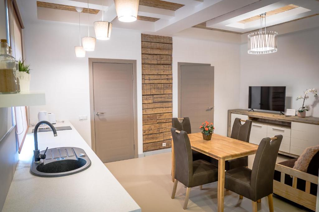a kitchen and dining room with a table and chairs at Apartment near the river with it's own entrance in Līgatne