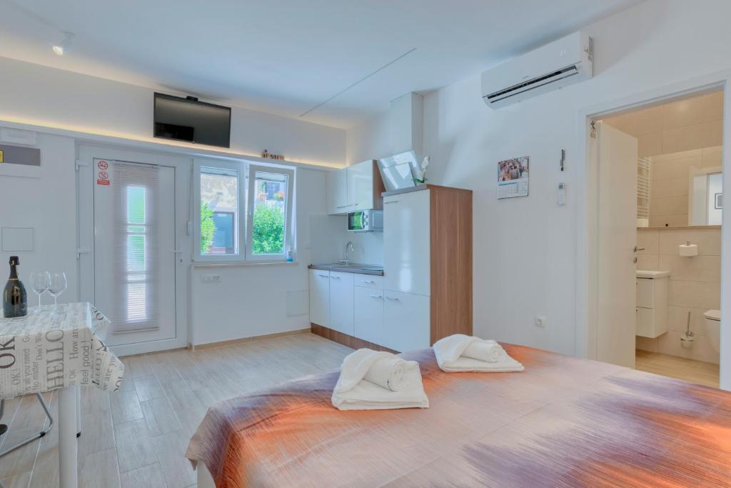 a bedroom with a bed with two towels on it at Apartment light in Pula in Pula
