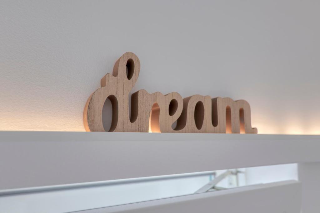 a shelf with a row of wooden figurines on it at Apartment light in Pula in Pula