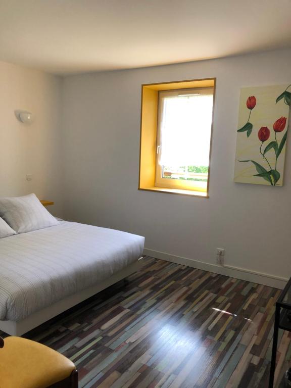 מיטה או מיטות בחדר ב-Relais d’Arbigny
