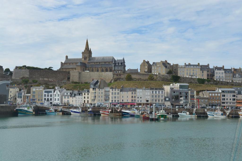 a group of boats are docked in a harbor at Granville plage normandie mont saint Michel in Granville