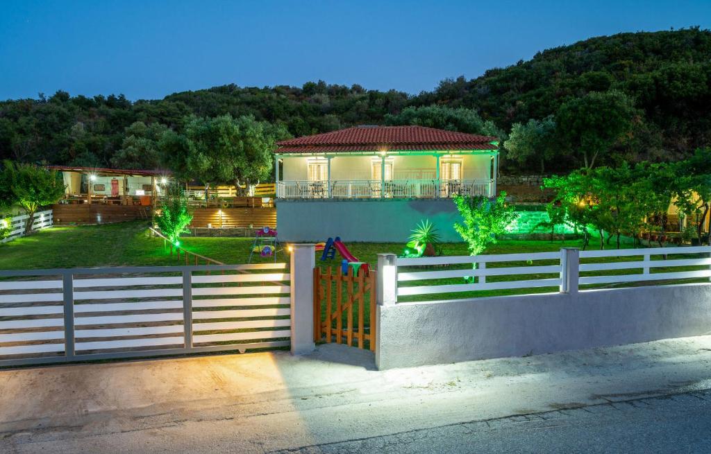 a house with a fence in front of it at Studios Vagelis in Kalamitsi