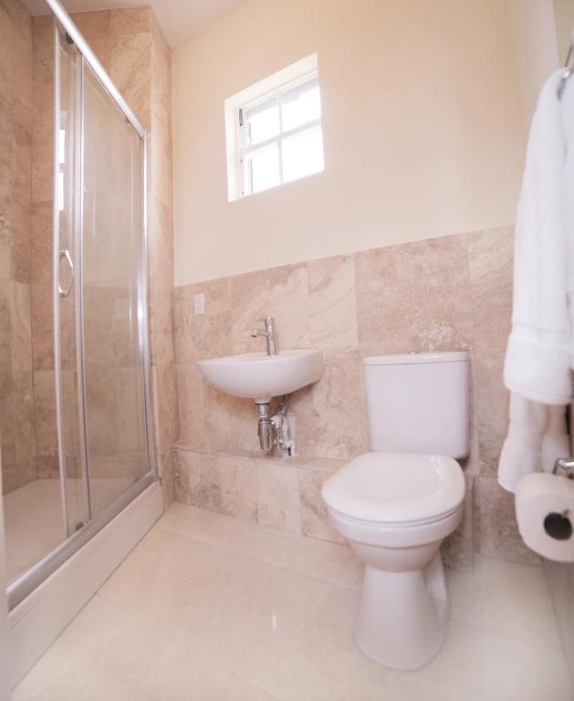 a bathroom with a toilet and a sink and a shower at Lantana Resort Barbados by Island Villas in Saint James