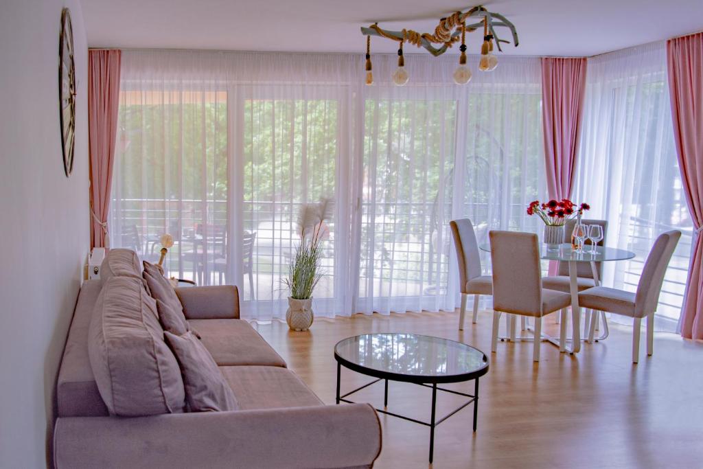 a living room with a couch and a table at Apartamenty Kornel in Pobierowo