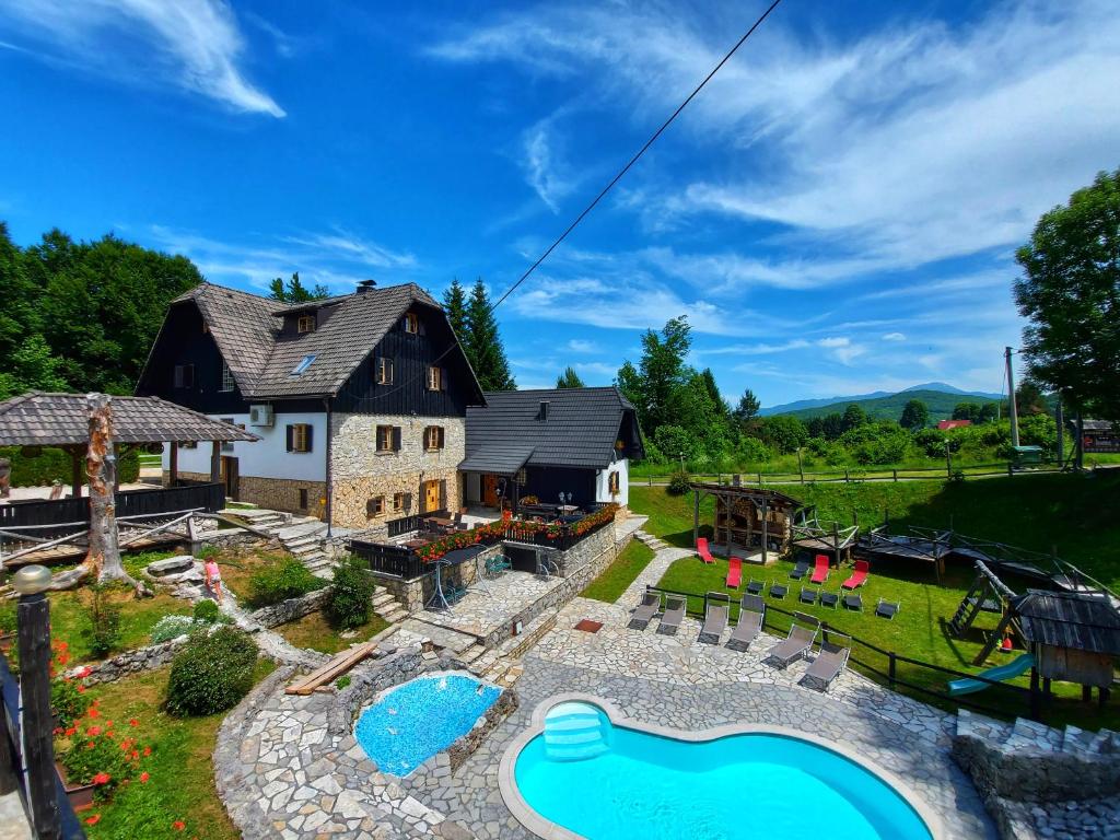 an aerial view of a backyard with a pool and a house at Plitvice Ethno House in Jezerce