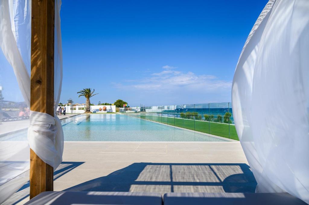 a swimming pool on the roof of a building at Smy Kos Beach & Splash in Mastichari