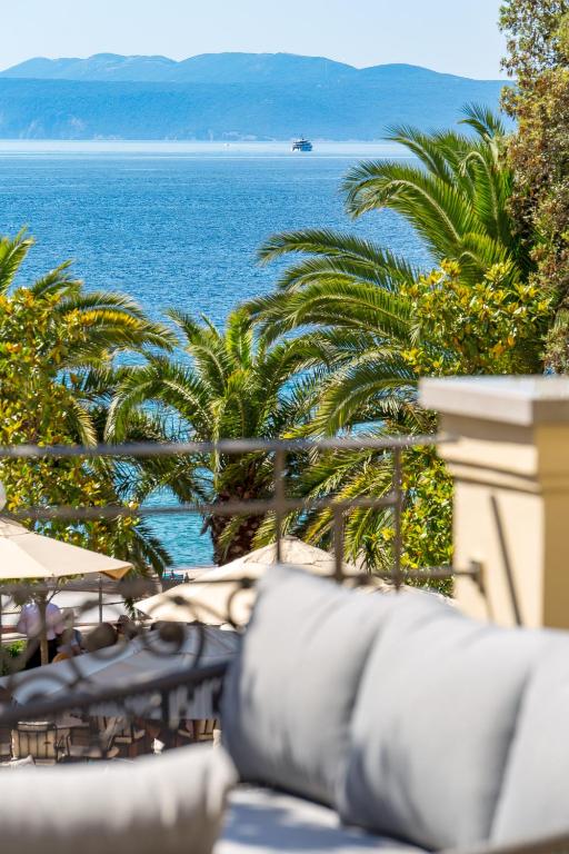 a view of the ocean from a resort patio at Plaza Apartments in Opatija