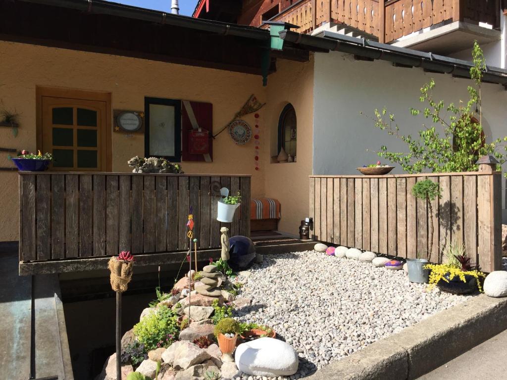 a garden with rocks and plants in front of a house at Gästehaus Schröder in Ruhpolding