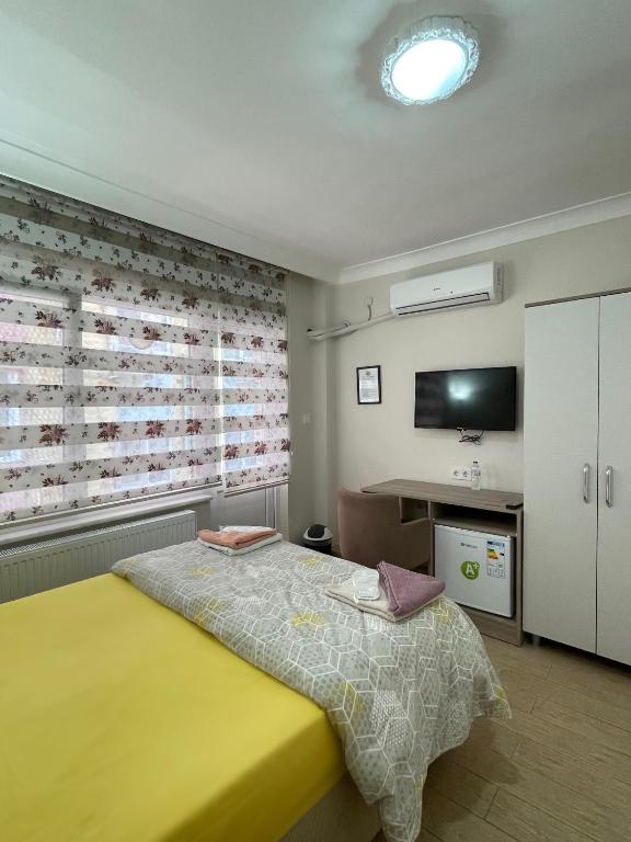 Postel nebo postele na pokoji v ubytování TEKİNLER OTEL