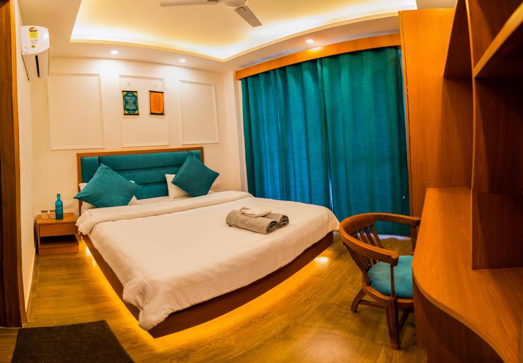 a bedroom with a bed and a blue curtain at Hotel The Moksham in Rishīkesh
