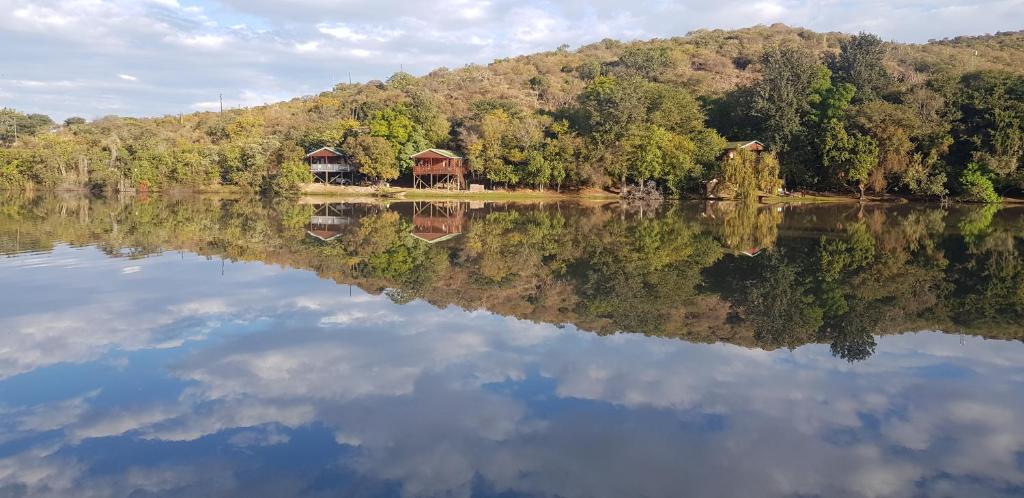 a reflection of a house on a lake at ATKV Klein-Kariba in Bela-Bela