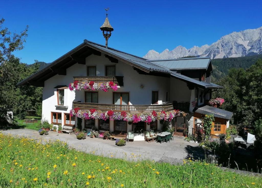 a house with flowers in front of it at Schererhof in Schladming