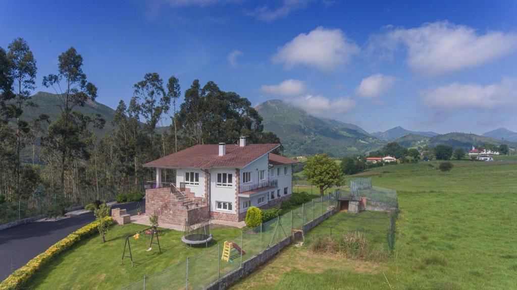 a house in a field with a fence at Casa Manuela, a 8 km de la playa in Llanes