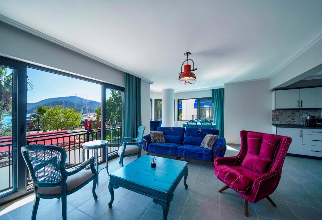 a living room with a couch and chairs and a table at Only Blue Rhapsody in Göcek