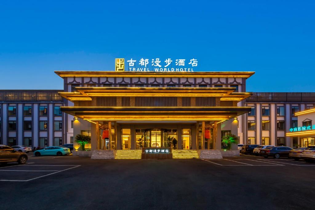 a hotel with a sign on the front of a building at 洛阳Travel World Hotel in Luoyang
