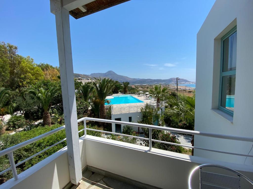 a balcony with a view of the pool at Hotel Plakures in Falasarna