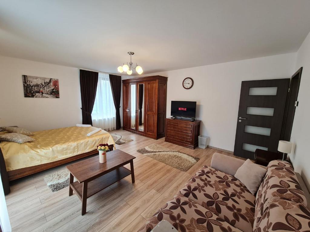 a living room with a bed and a couch at Select City Center in Târgu-Mureş