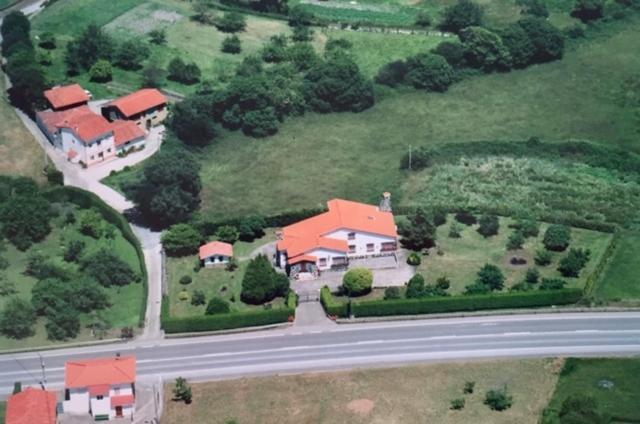 an aerial view of a house with a road at Finca Engracia in Cudillero