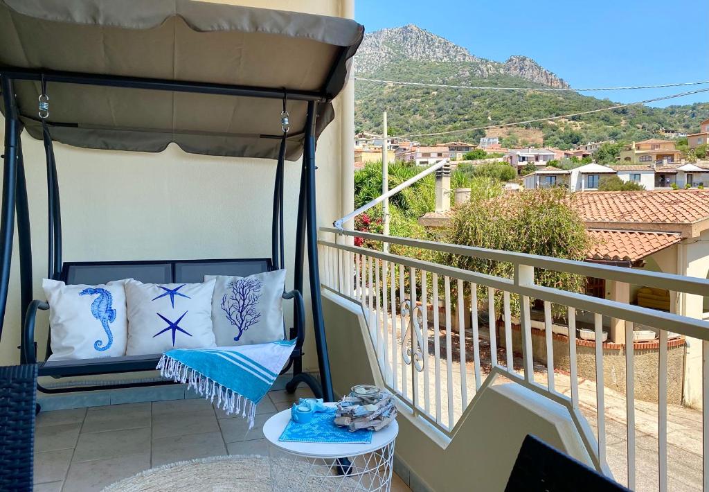a balcony with a gazebo with a table and a chair at Stella Marina in Santa Maria Navarrese