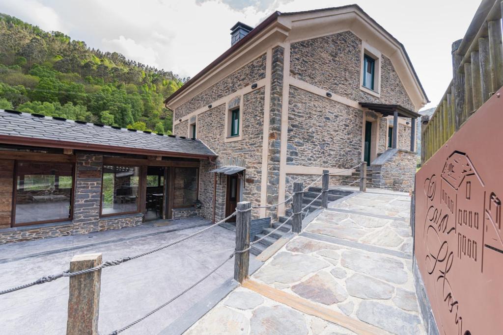 a stone building with a walkway in front of it at Apartamentos Rurales Casa Llongo in Coaña