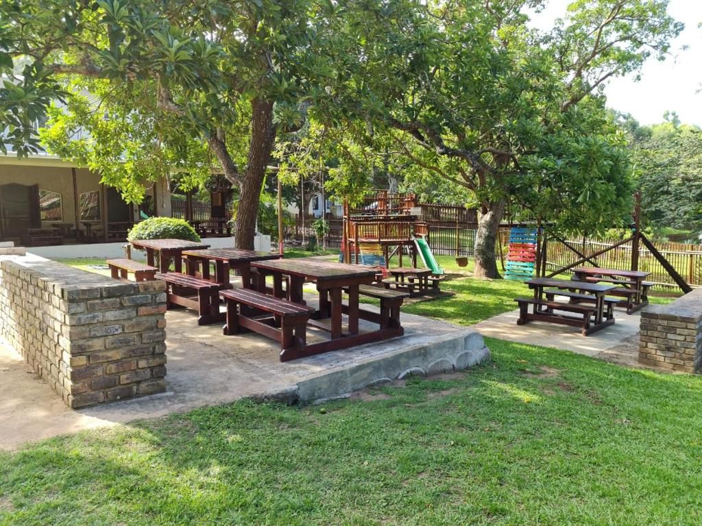 a group of picnic tables in a park at Sherwood Forest 2 Marina Drive in Southbroom