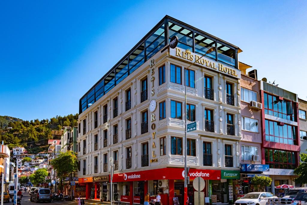 a large white building on a city street at Reis Royal Hotel in Fethiye