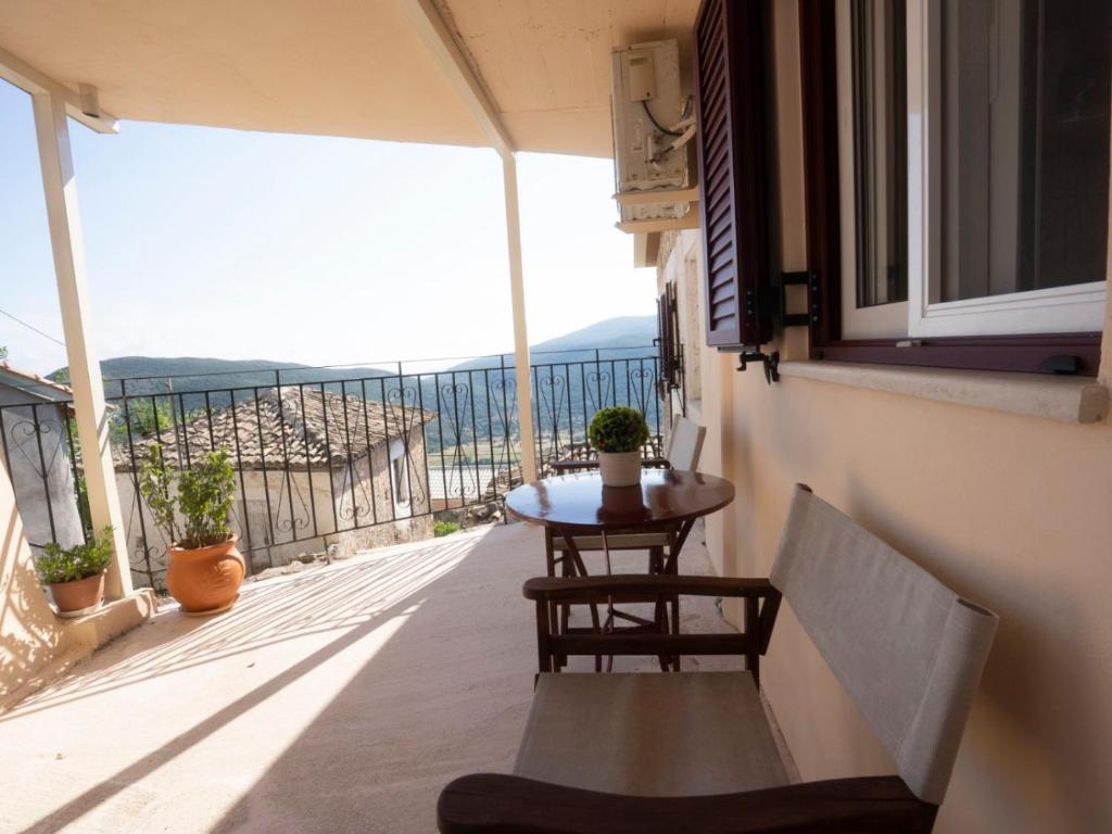 a balcony with a table and chairs and a view at Manto Apartments Lefkada in Évyiros