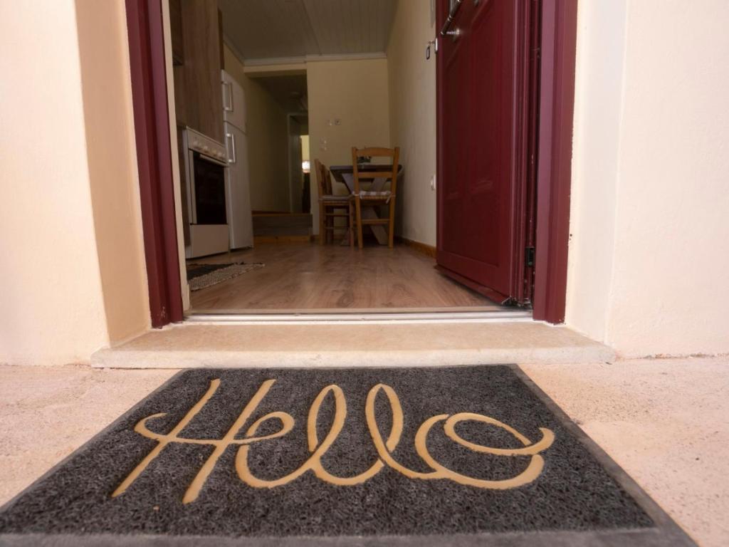 a welcome mat in front of a door at Manto Apartments Lefkada in Évyiros